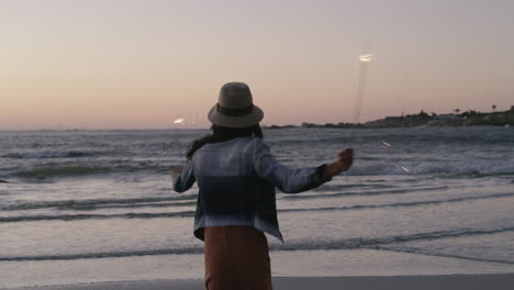 a woman holding sparklers while spending time