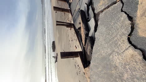 Panning-vertical-view-of-damage-caused-by-storms-at-the-Seacliff-Pier-in-January-2023