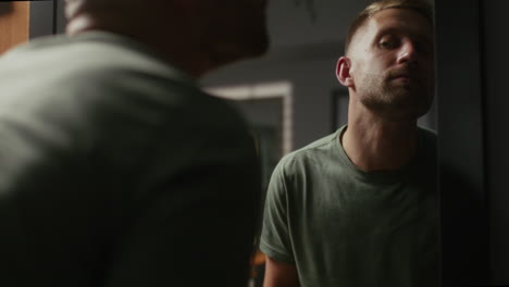 man looking at himself in a mirror