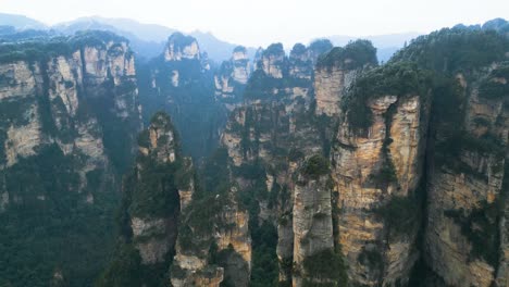 aerial view captures zhangjiajie national park in wulingyuan, hunan, china, featuring the renowned karst mountains - the avatar hallelujah mountains, set against a misty and overcast sky