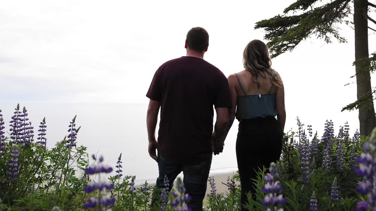 Couple walking to lookout spot overlooking the beach in Kenai, Alaska