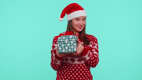 joyful girl in red christmas sweater with deers presenting christmas gift box shopping holiday sale
