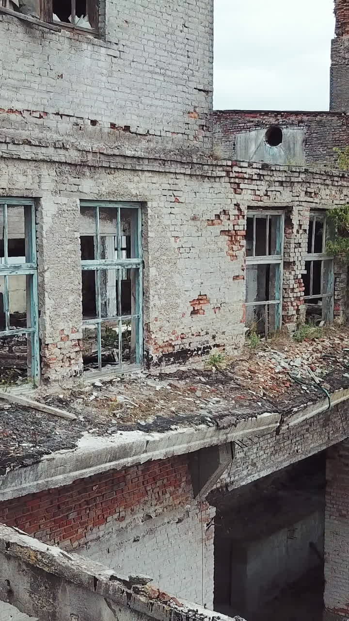 Aerial view of a destroyed factory during the war. Industry in ruins. Vertical video