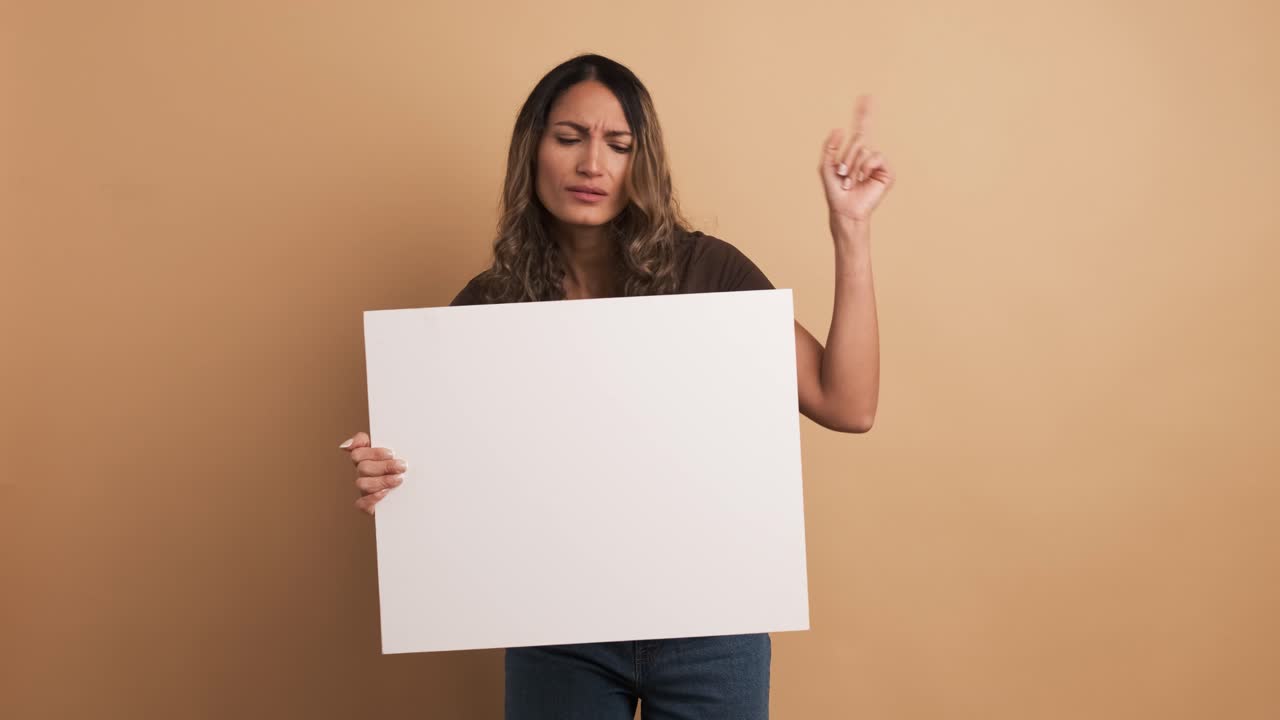 Woman holding a blank panel and gesturing negatively