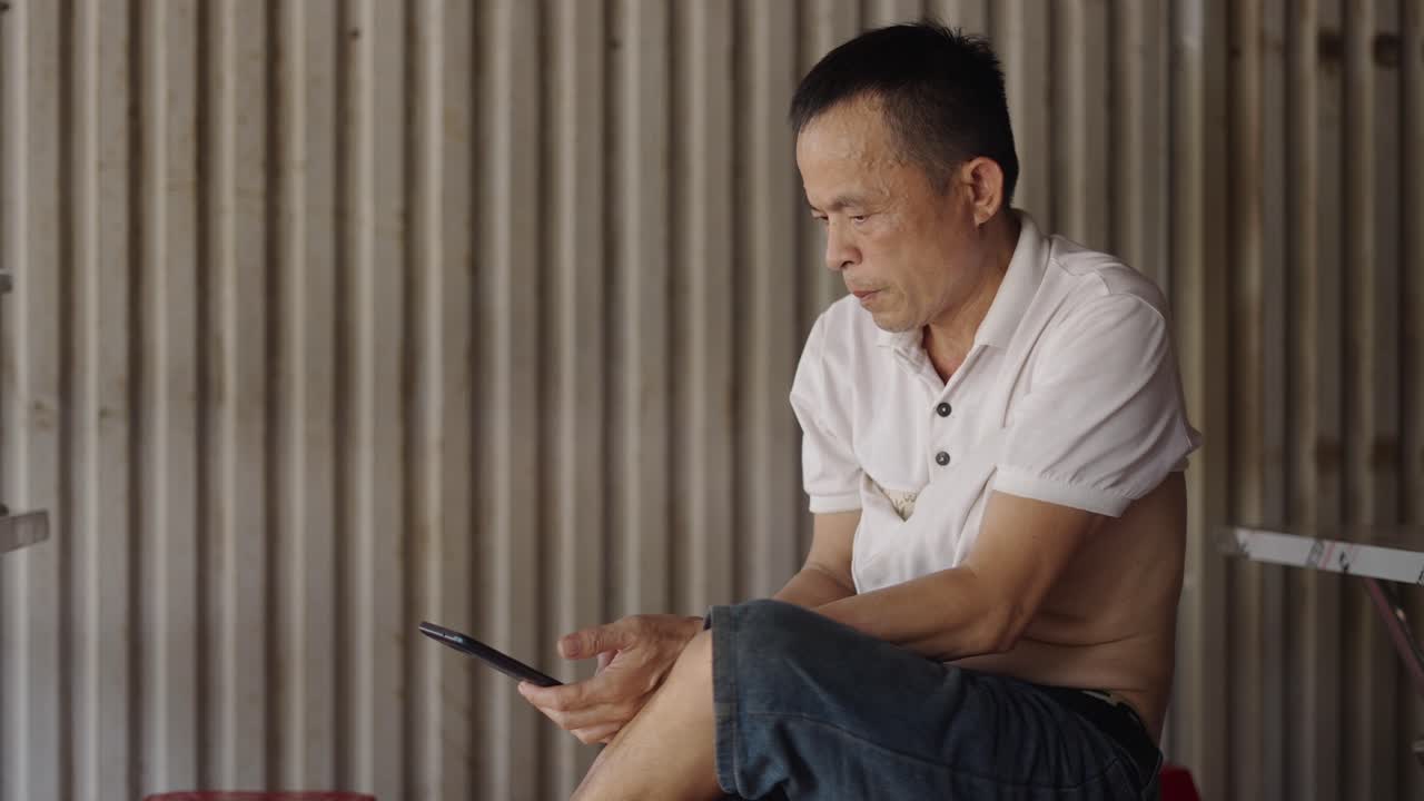 Older Man Using Smartphone Outdoors