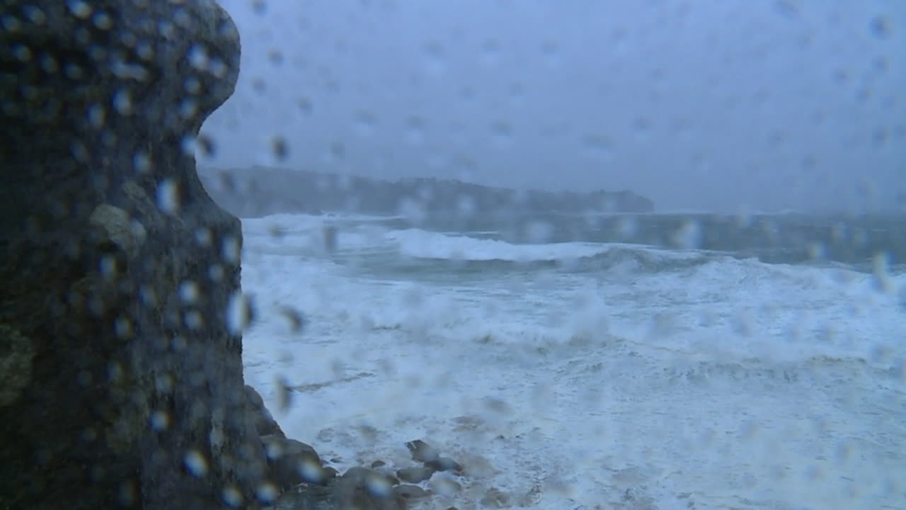 Stormy Ocean View Through Rain-Streaked Window