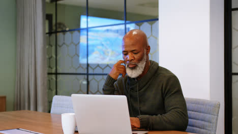 Senior-man-using-laptop-in-conference-room-4k