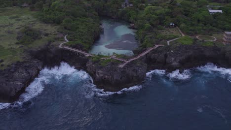 Reveal-shot-of-the-famous-weekuri-lagoon-during-sunrise-with-no-people-at-Sumba-Island,-aerial