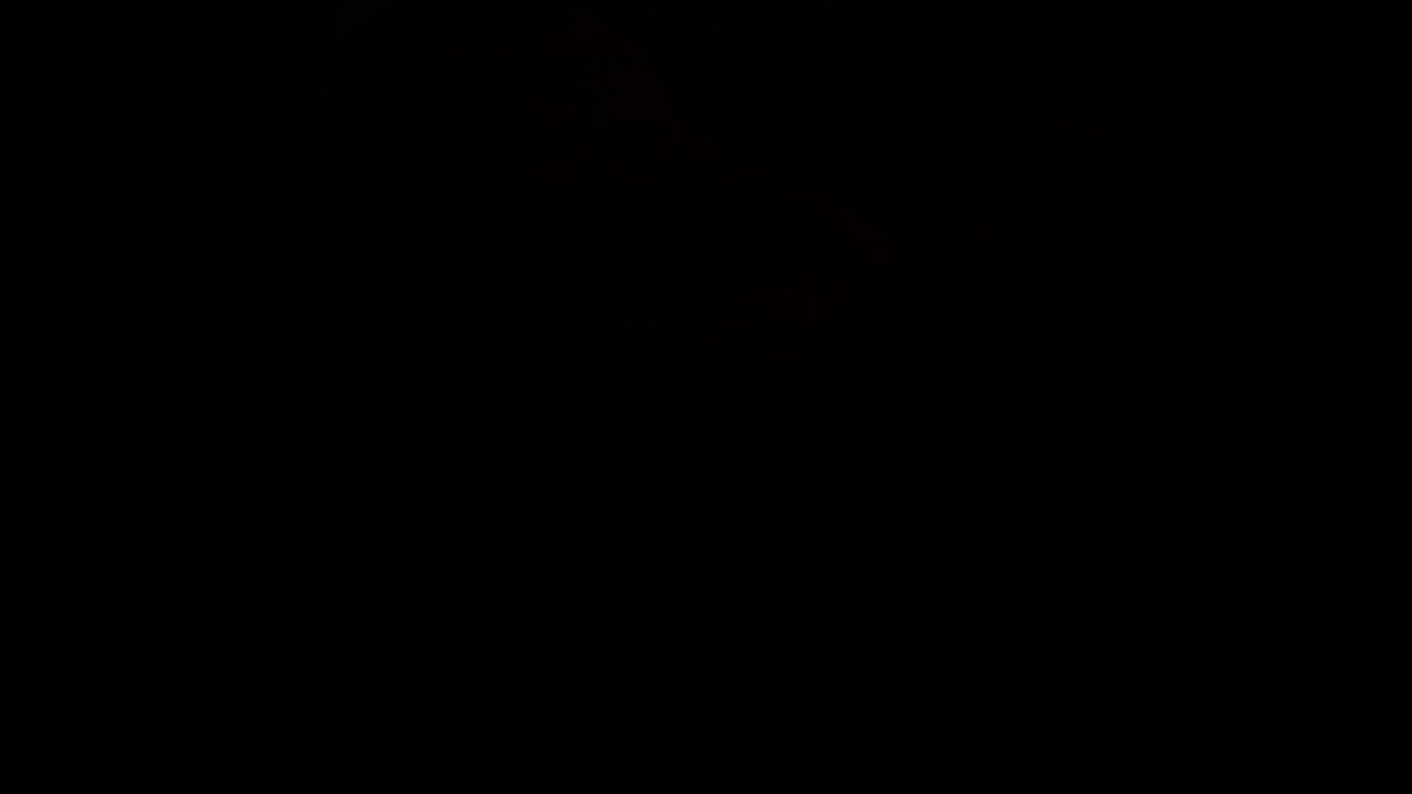 Unconscious Person on Ground with Flashing Police Lights at Night. Close up Of Person's Hand.