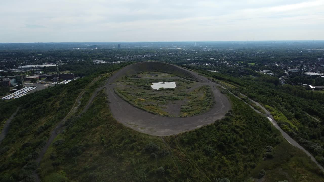 Aerial View of a Hill with a Small Lake