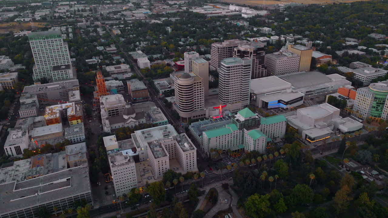 Multi-storied contemporary buildings in Sacramento downtown. Evening footage from drone.