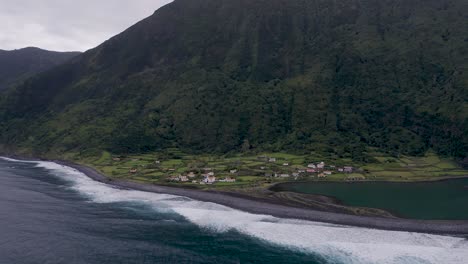 coastal rural village, a church, a lagoon, with lush green cliffs landscape, fajã de santo cristo, são jorge island, the azores, portugal