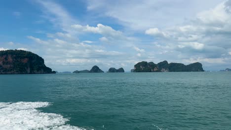 pov from a long tail boat on a boat tour that visits different islands and lagoons in the hong islands, thailand