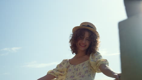 positive girl smiling camera in front blue sky lightened summer sunlight closeup