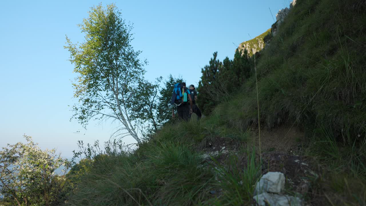 Men Hiking On Grignetta Mountain In Mandello del Lario, Lombardy, Italy. low angle, static shot