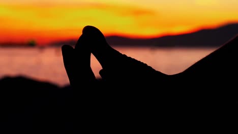 woman performing yoga on the beach