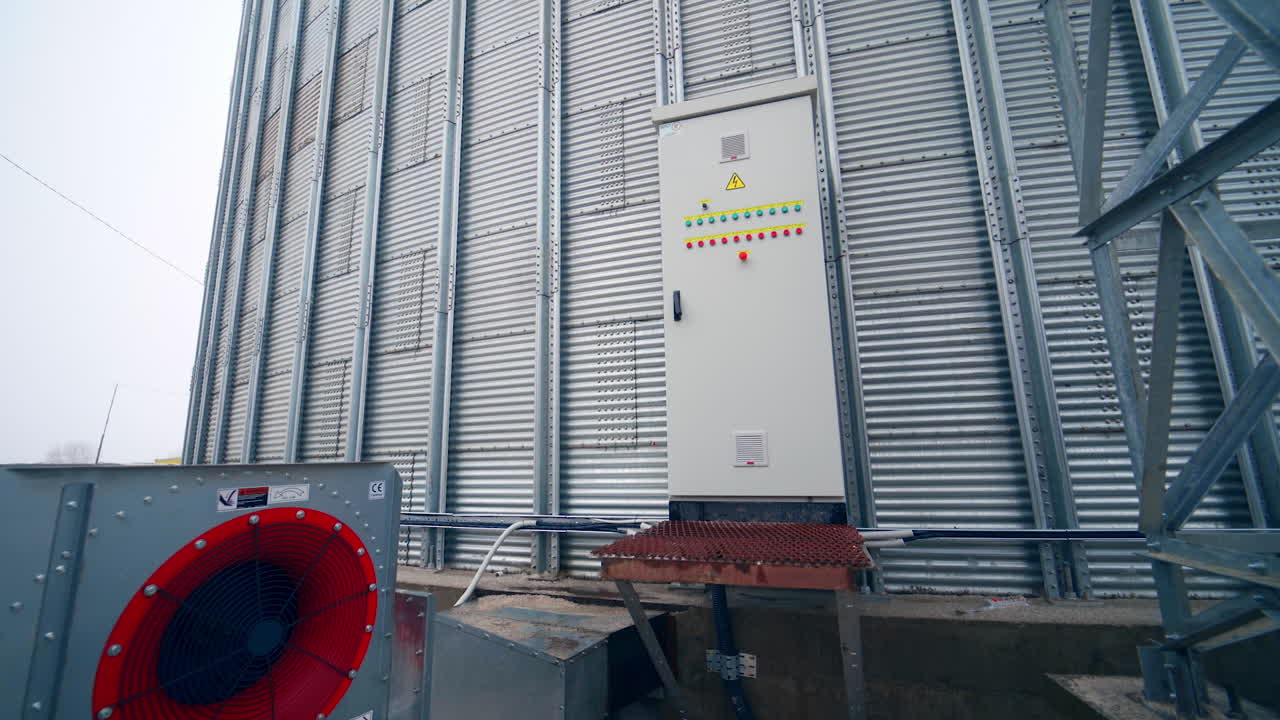 Work of an elevator with a generator. Steel grain silos for grain storage. Grain storage elevators with generator