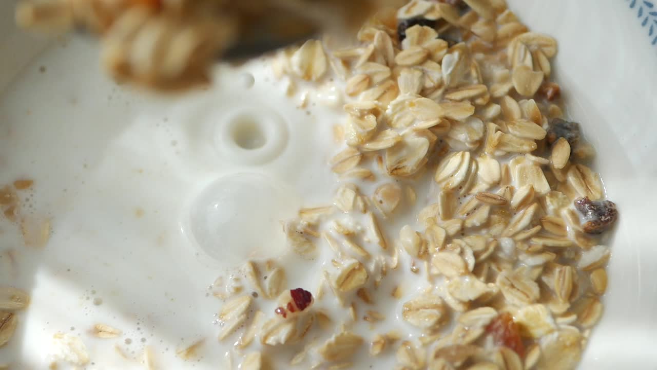 Bowl of oatmeal with milk and raisins