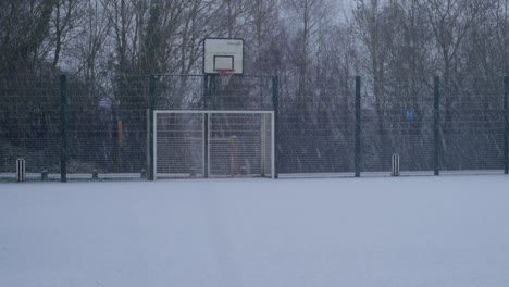 Empty-basket-ball-court-in-a-playground-in-winter