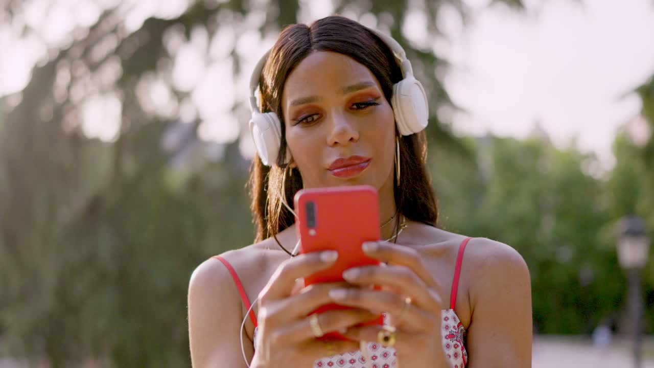 Person Listening to Music with Headphones and Smartphone Outdoors