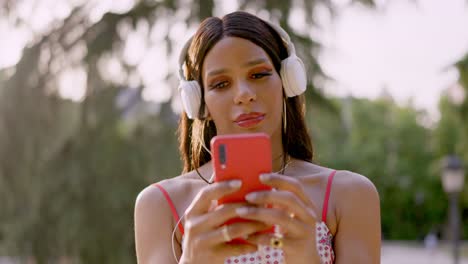 person listening to music with headphones and smartphone outdoors