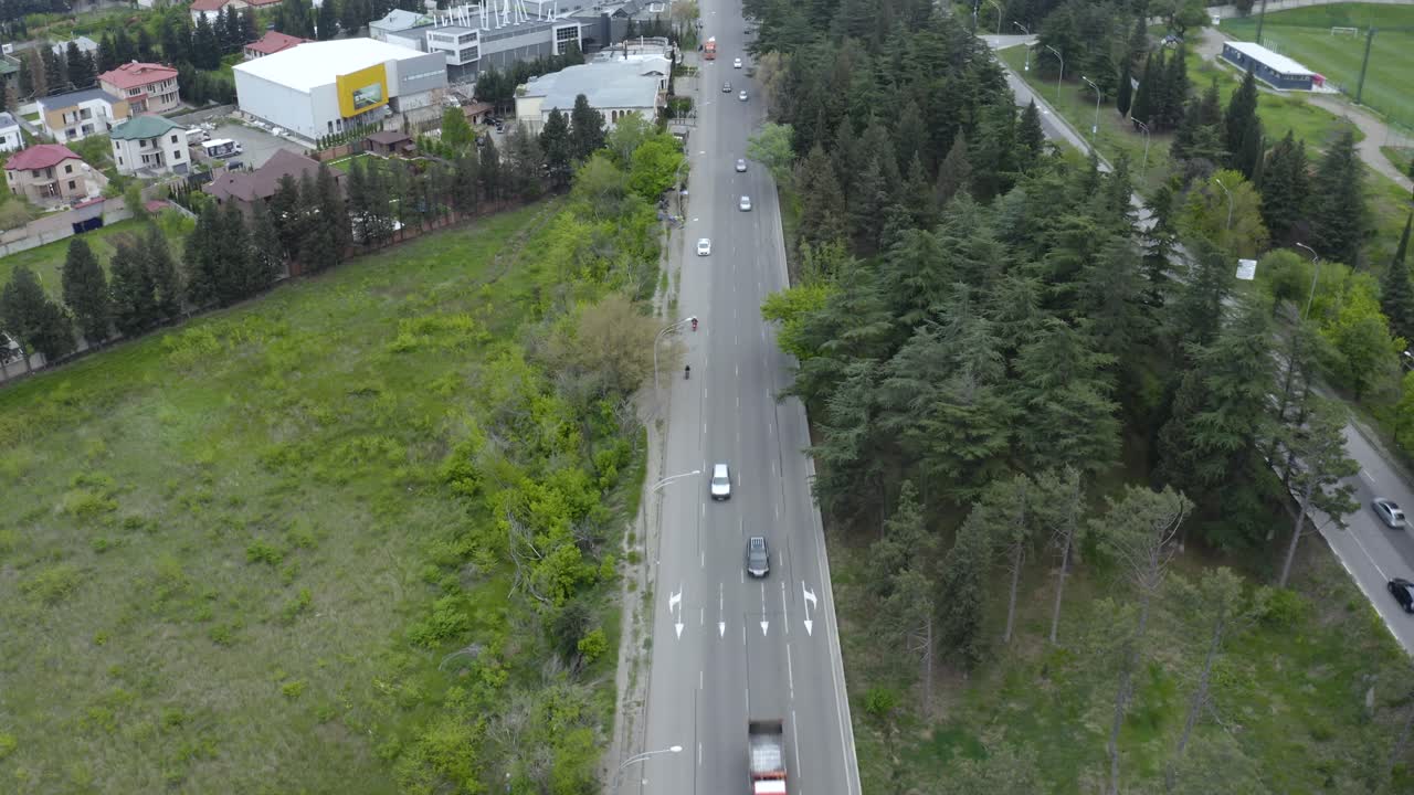 Transport Vehicles Travelling On The Asphalt Road In Tbilisi, Georgia With No Traffic At Daytime - aerial shot