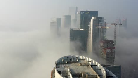 foggy cityscape with skyscrapers and construction sites