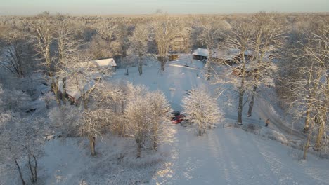 Aerial-view-over-a-snowy-landscape-with-some-beautiful-houses-on-a-sunny-day-in-Karlskrona,-south-of-Sweden