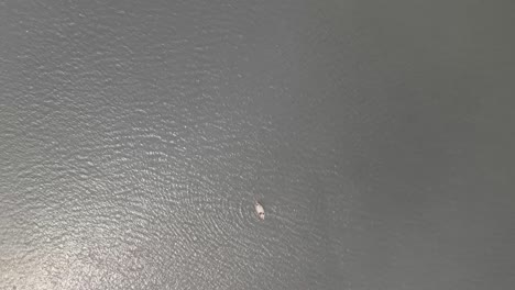 4k drone shot of a boatman drives a boat