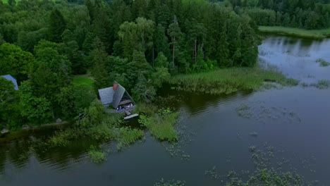 Wide-shot-of-lakeside-cabin-admist-nature-with-people-celebrating