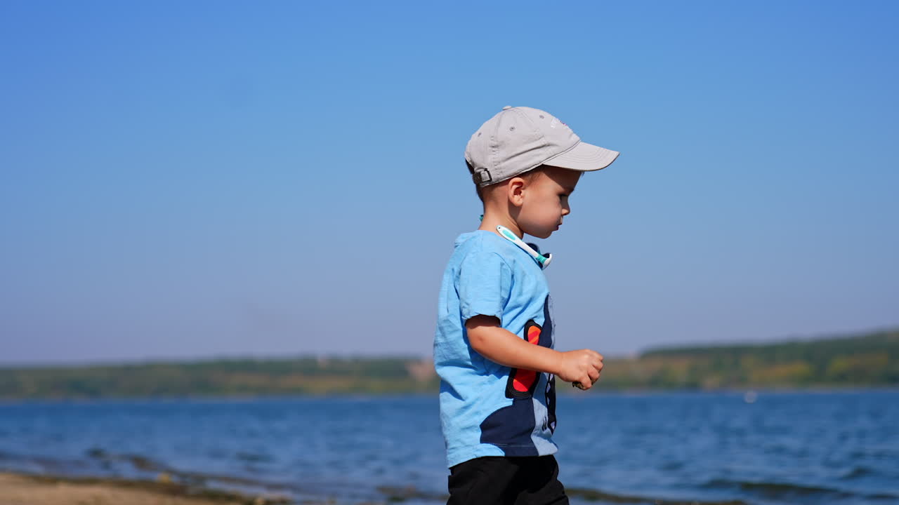 Small infant boy playing on a beach. Summer playing on sunny day.