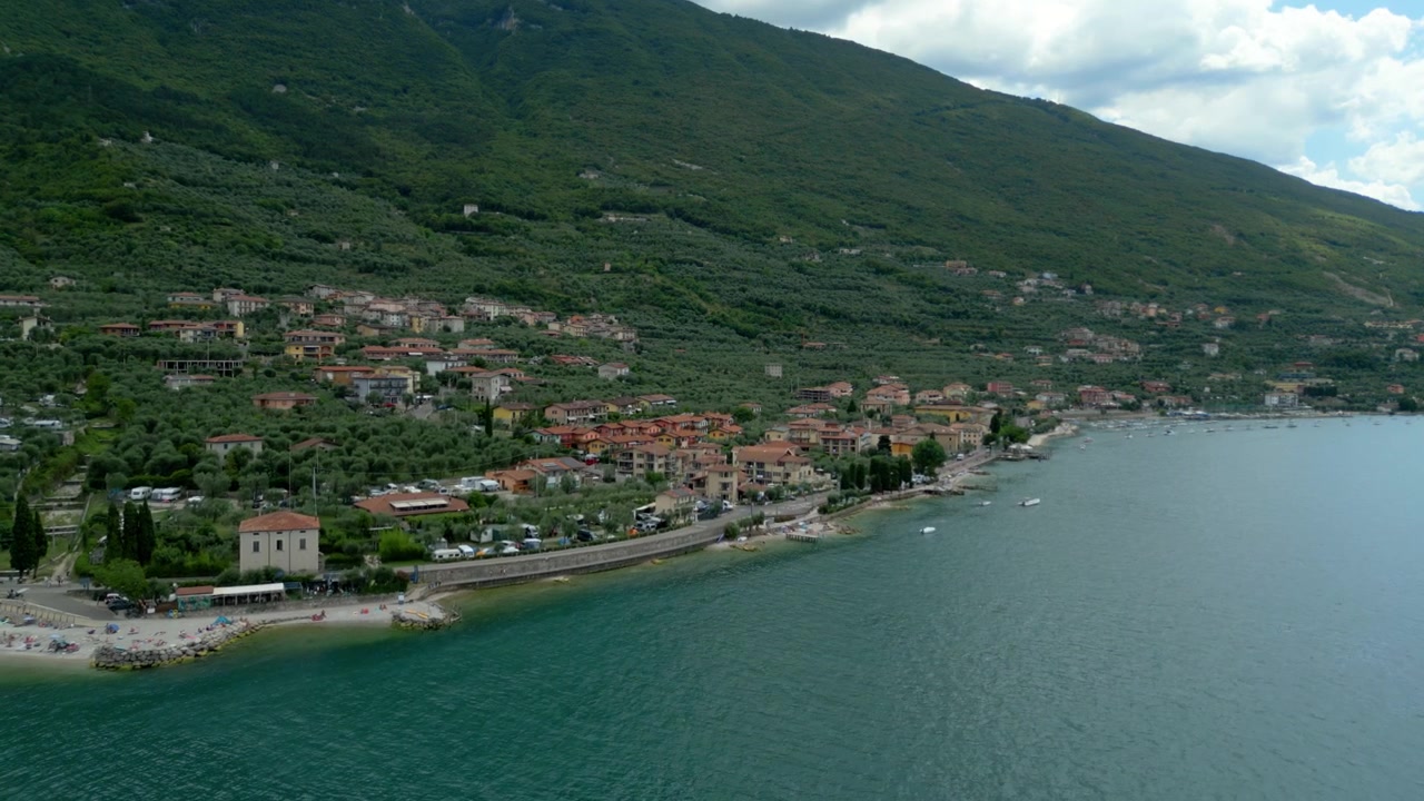 Aerial view of Malcesine town along Lake Garda shoreline with Monte Baldo backdrop