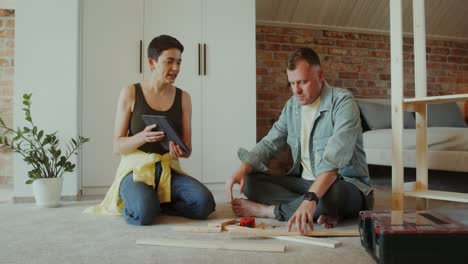 couple assembling furniture at home