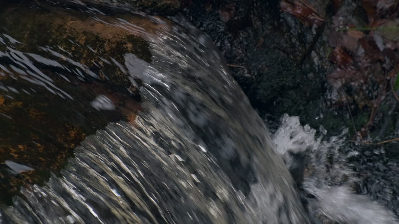 Flowing water stream, waterfall in the fall 4K 60P Slow motion