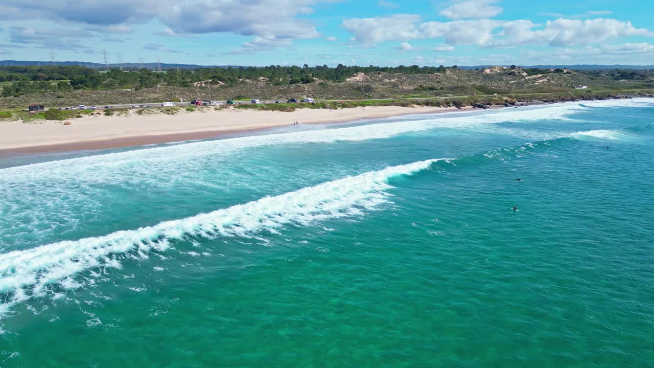 Ocean waves roll onto Praia de São Torpes, Sines on a sunny Alentejo spring day