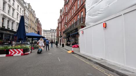 people walking on long acre, london street