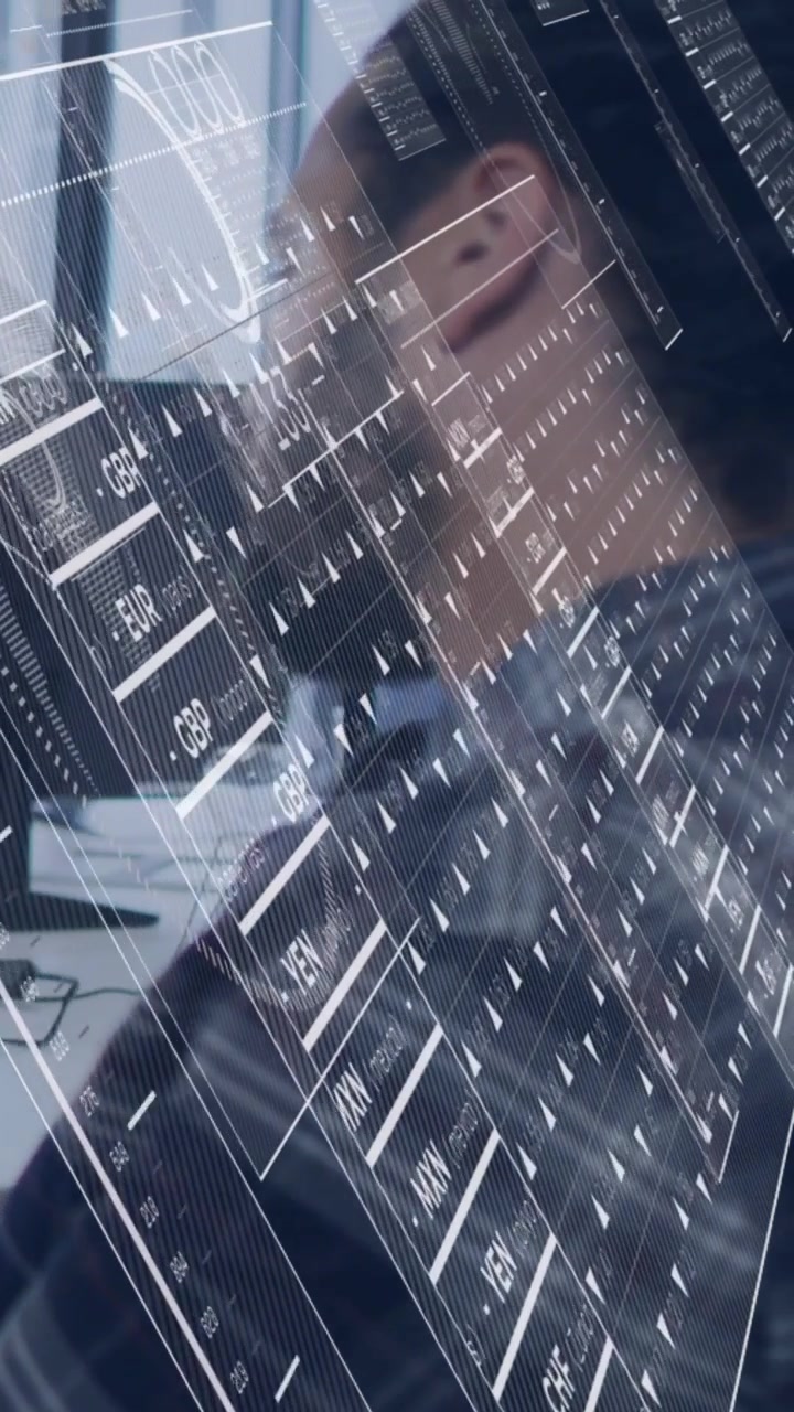 Vertical video: Bearded man monitoring markets at desk, live finance feed overlaying HUD rates grid