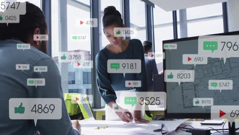 in office, business professionals collaborating with animation of social media icons floating
