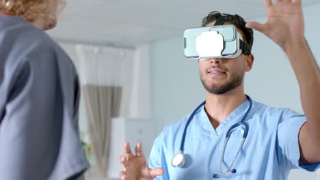 biracial male doctor using vr headset with diverse doctors at hospital, slow motion