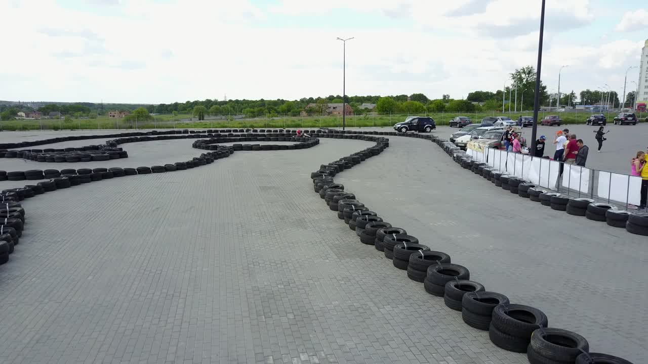 People Racing In Karts. VINNITSA, UKRAINE - MAY 2017: Europe Day, people driving karts on a kart track