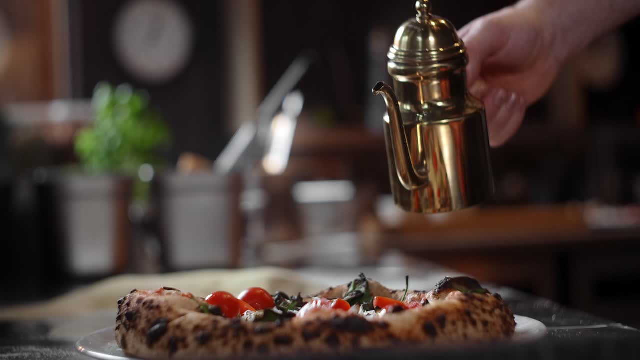 Chef Drizzling Olive Oil on Pizza