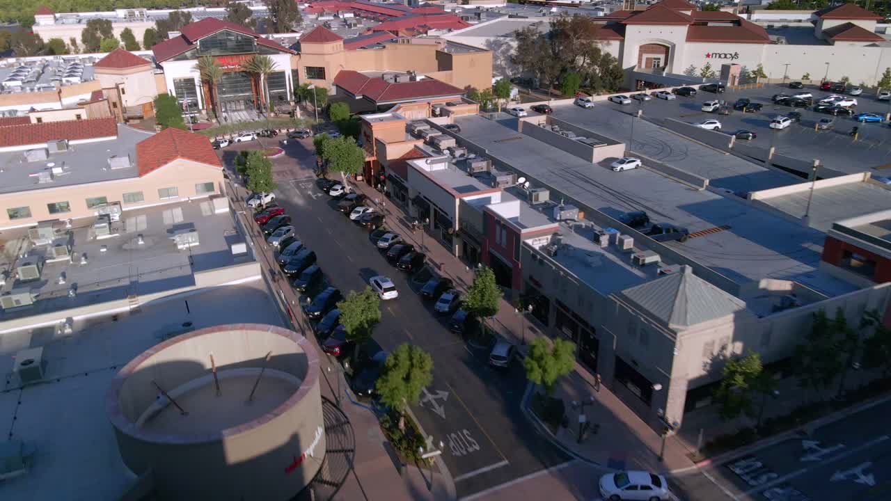 Drone tracking cars driving toward the Valencia town center, in sunny CA, USA