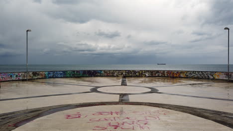 graffiti-covered seascape: a view from a circular stone plaza