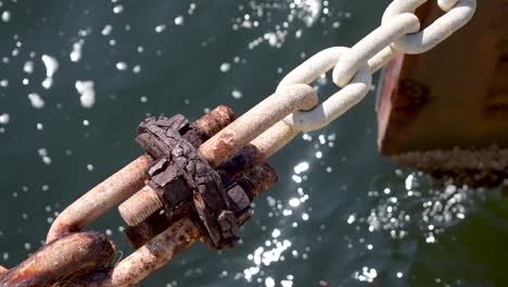 gigantic rusty chain over dark water