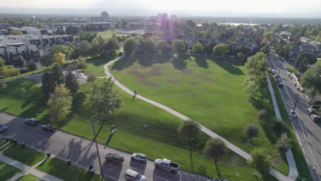 A-4K-drone-shot-of-a-sunny-day-over-Hallack-Park,-among-a-quiet-and-pristine-neighborhood-between-Sloans-Lake-and-Empower-Field,-in-Denver,-Colorado