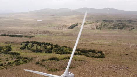 tilting drone shot of a wind turbine on a moorland on the outer hebrides