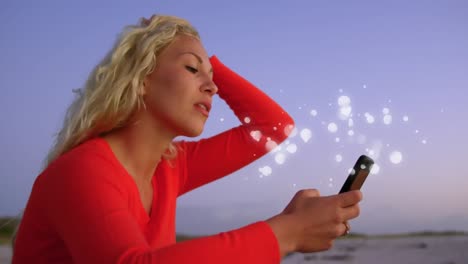 Animation-of-multiple-white-spots-over-woman-using-smartphone