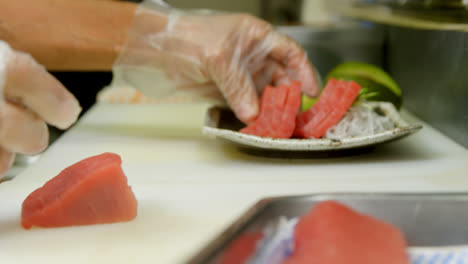 Male-chef-arranging-sushi-in-a-plate-at-kitchen-4k