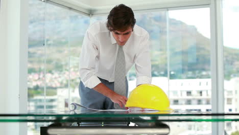 Architect working on blueprints