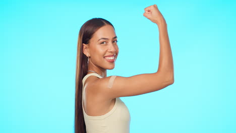 face, smile and woman flex muscle in studio